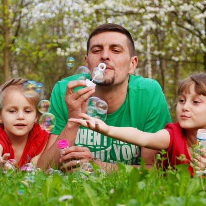 Father with two daughters on grass