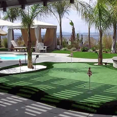 Golf putting green practice by swimming pool ocean palm tresses gazebo green hotel backyard artificial grass synthetic green turf lawn