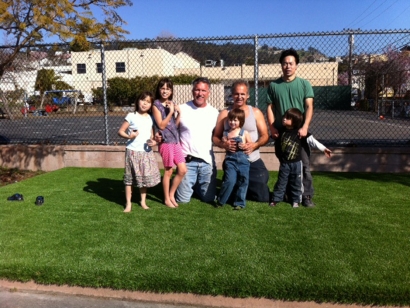 Artificial grass family four children kids synthetic lawn turf backyard