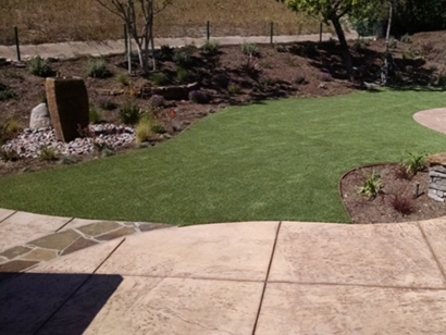 Synthetic turf green backyard stones square pavers landscaping ideas landscape lawn flowers fake artificial grass