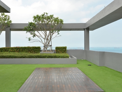 Artificial grass, synthetic turf installation on a rooftop, rooftop garden, trees, ocean