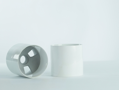 Two white premium aluminum golf cups on white background