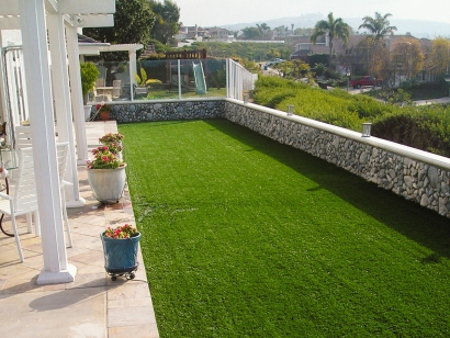 Artificial grass lawn with ocean view and stone retaining wall